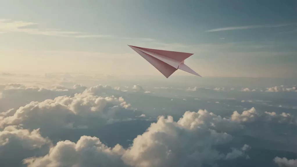 Avión de papel volando sobre las nubes en un cielo claro, simbolizando una marca auténtica y ligera en su comunicación.